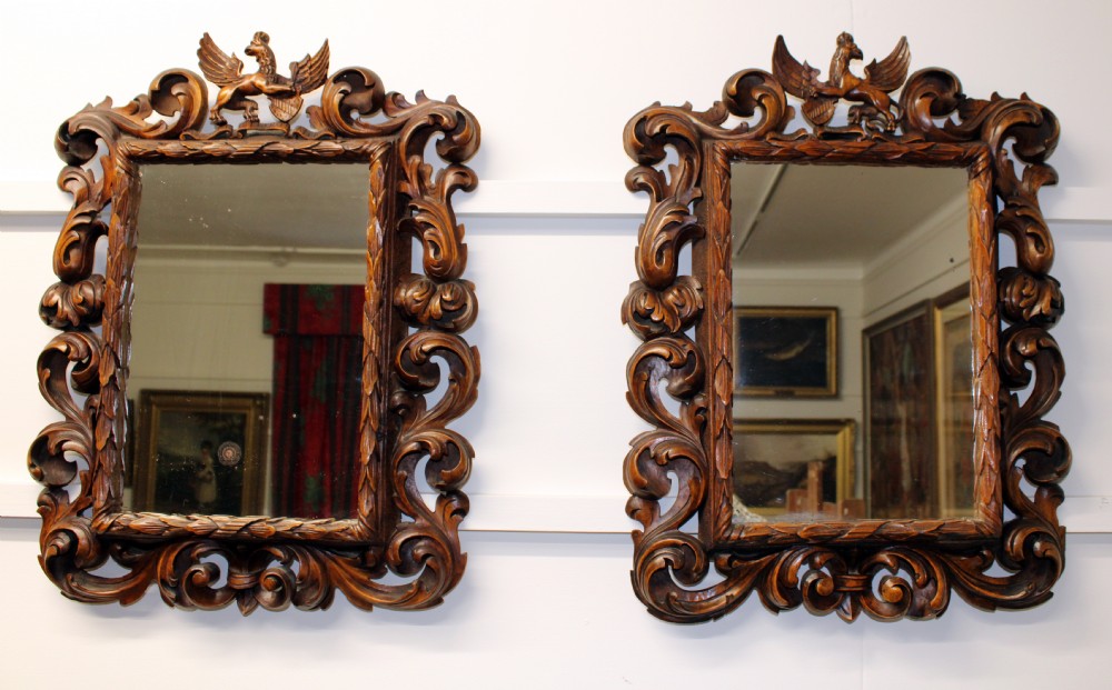 A pair of finely carved walnut  mirrors. 