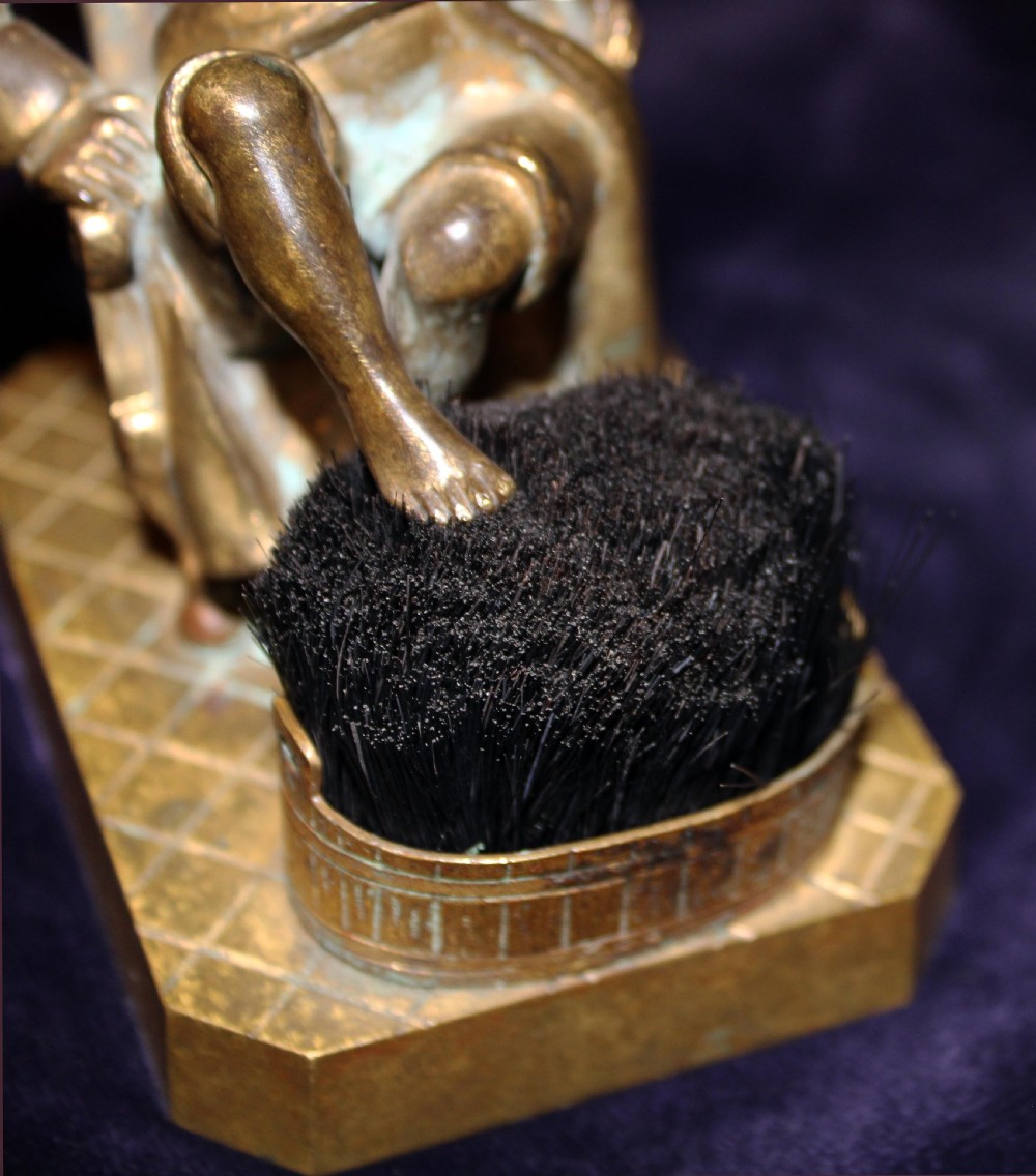 An antique gilt bronze desk accessory depicting an anthropomorphic fox wearing a nightgown and nightcap seated in an armchair with his foot resting on a bristle pen wiper. View IV