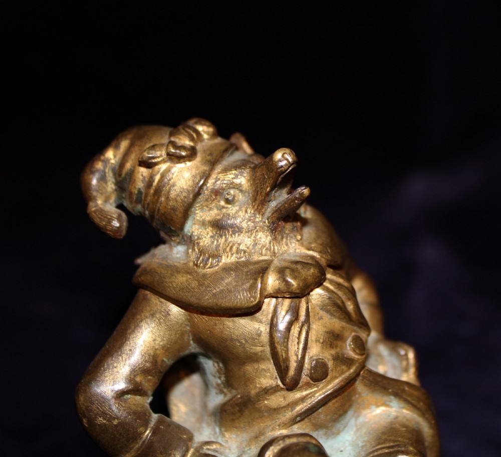 An antique gilt bronze desk accessory depicting an anthropomorphic fox wearing a nightgown and nightcap seated in an armchair with his foot resting on a bristle pen wiper. View VIII