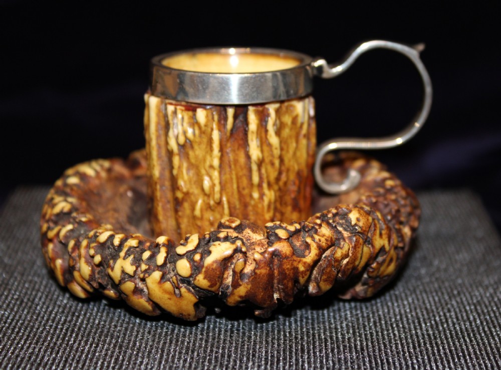 An antique chamberstick crafted from textured brown deer antler with a fitted silver rim and loop handle. View III