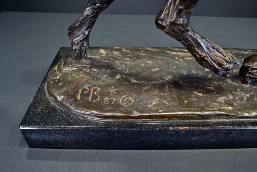 A dark bronze sculpture of a trotting cob horse mounted on a rectangular black stone base. View IV