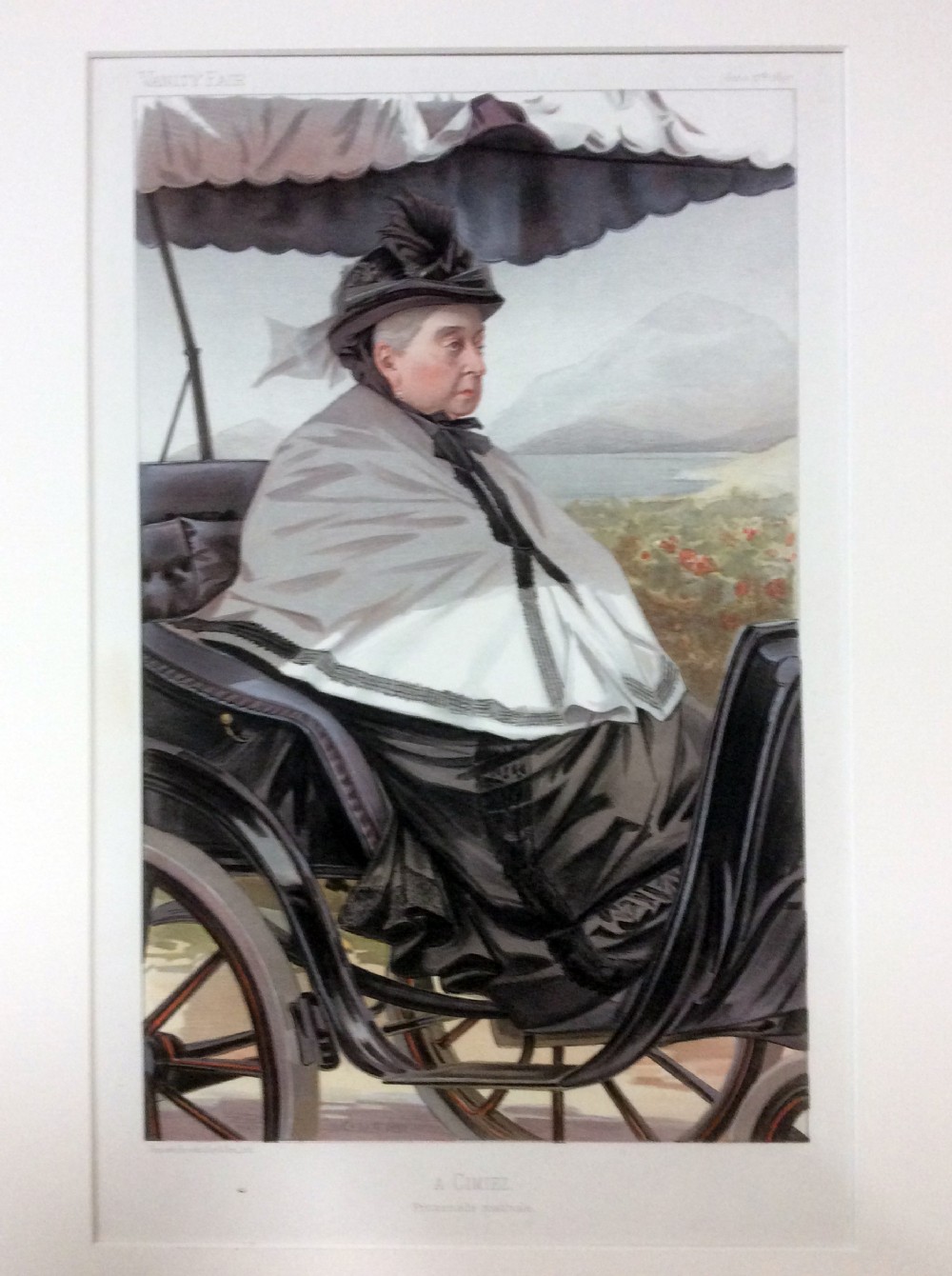 A framed 19th-century chromolithograph print depicting Queen Victoria seated in a carriage wearing a grey shawl and bonnet.