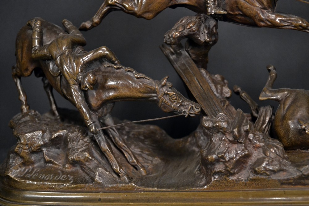 A patinated dark brown bronze sculpture depicting three steeplechase horses and jockeys jumping over a fence, mounted on a dark oval base. View III