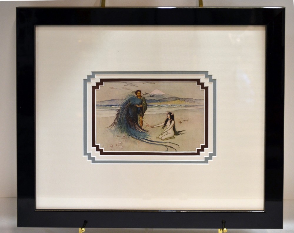 A mounted colour book print depicting two figures on a beach with Mount Fuji visible in the background, set within a multi-tiered stepped frame mount. View II