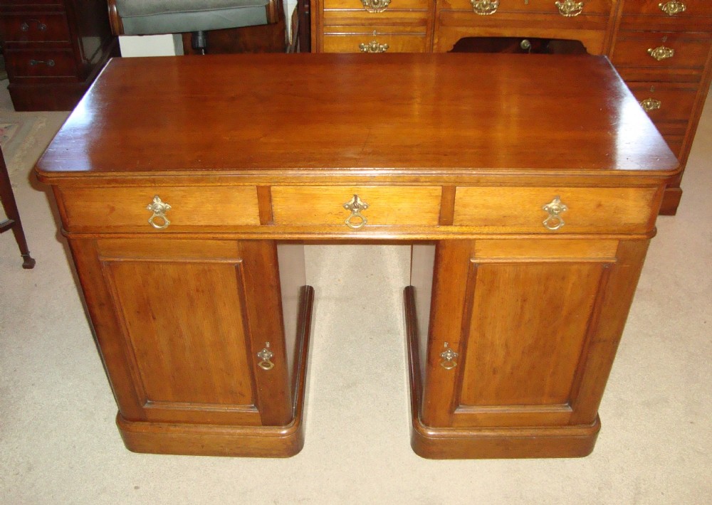 A well made, solid golden walnut, Victorian pedestal desk.