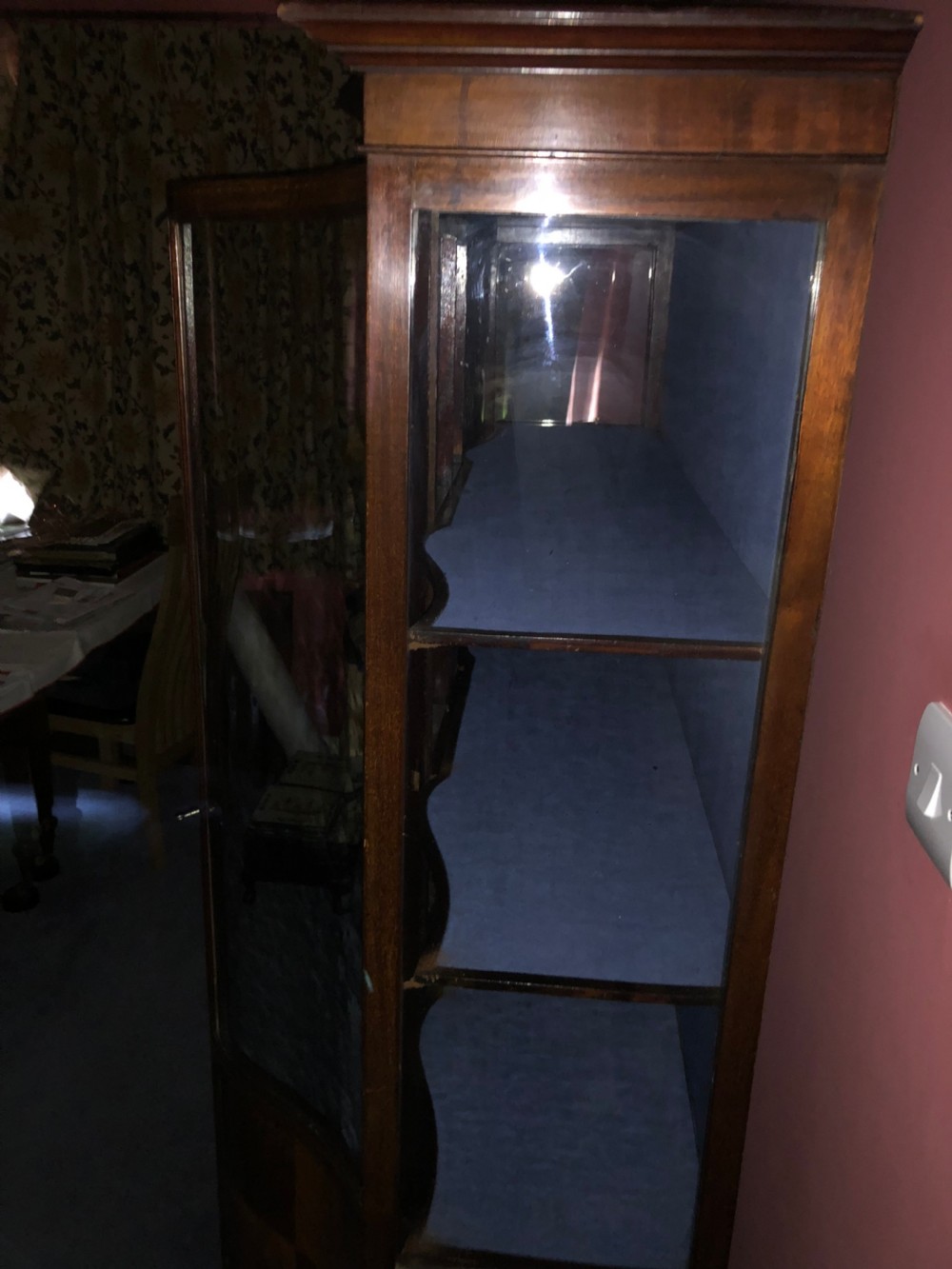 A late Victorian mahogany glazed display cabinet featuring three central glass doors above geometric inlaid timber panels, resting on cabriole legs with a blue fabric-lined interior. View II