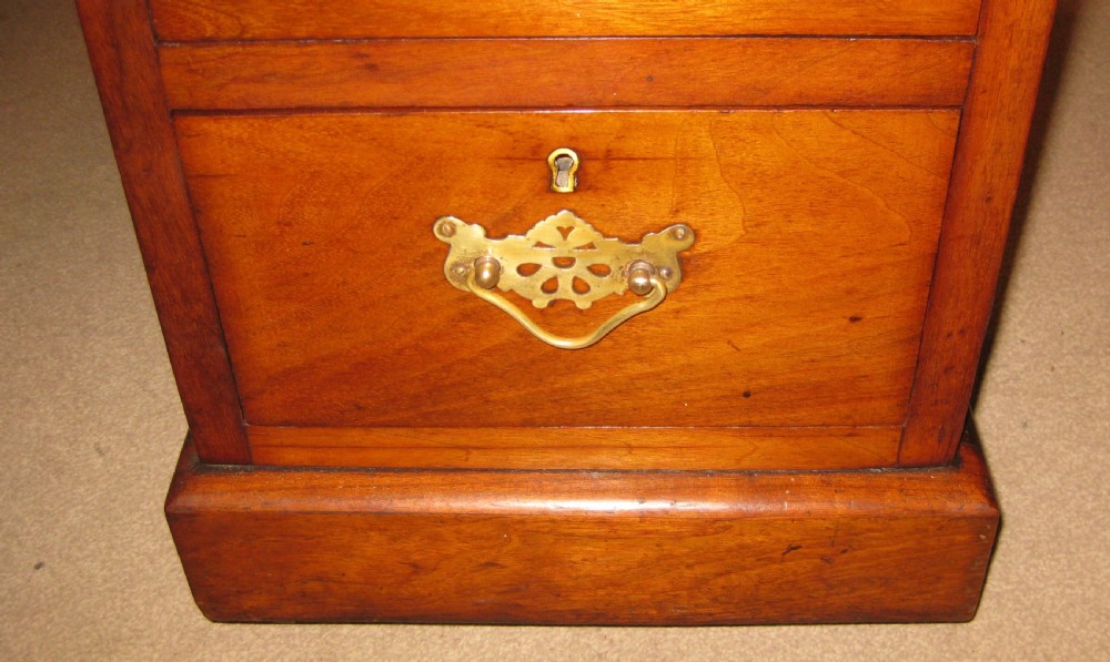 A Victorian walnut pedestal desk featuring nine drawers with decorative brass handles and a dark leather inset writing top. View IX