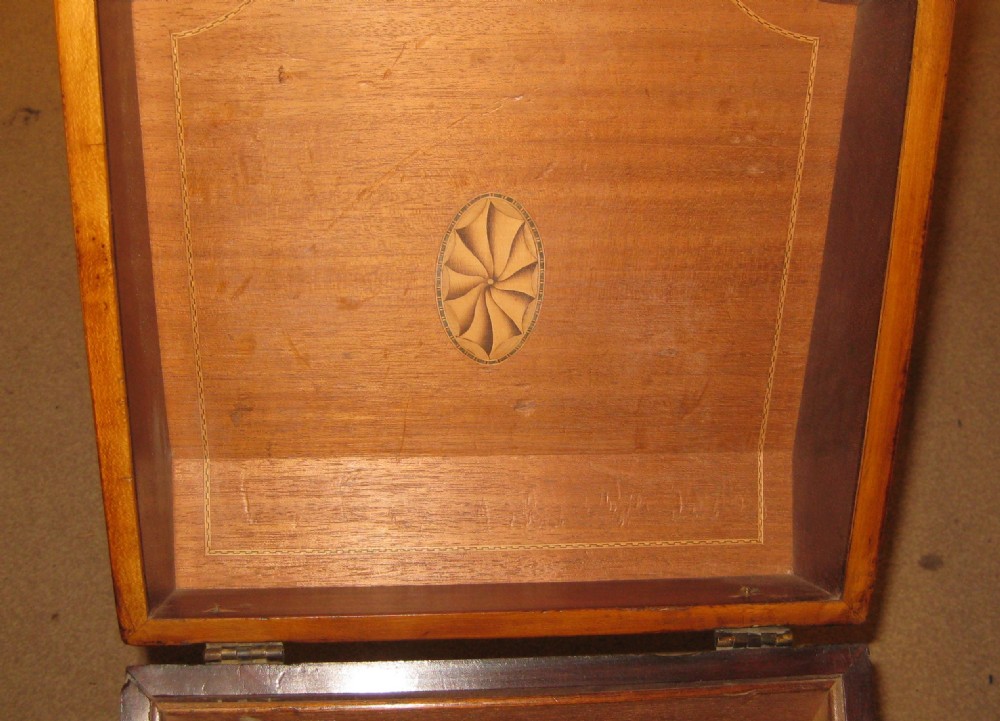 An 18th-century Georgian mahogany slope-front box featuring a serpentine front, crossbanded inlay borders, an oval shell marquetry medallion on the lid, and a brass keyhole escutcheon. View VII