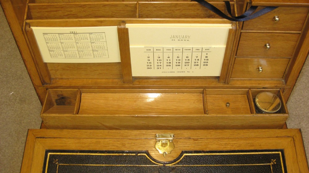 A rectangular Coromandel wood stationery box with polished brass strap hinges and a central keyhole escutcheon. View II