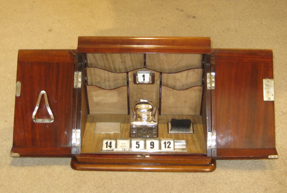 An antique mahogany stationery cabinet featuring a sloped double-door front with inlaid boxwood stringing and a central brass keyhole escutcheon. View II