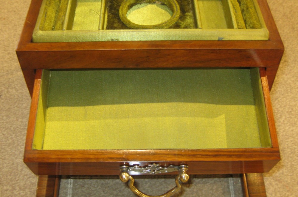 A rectangular Victorian walnut jewellery box featuring bevelled glass panels on the top and drop front with brass hardware. View III
