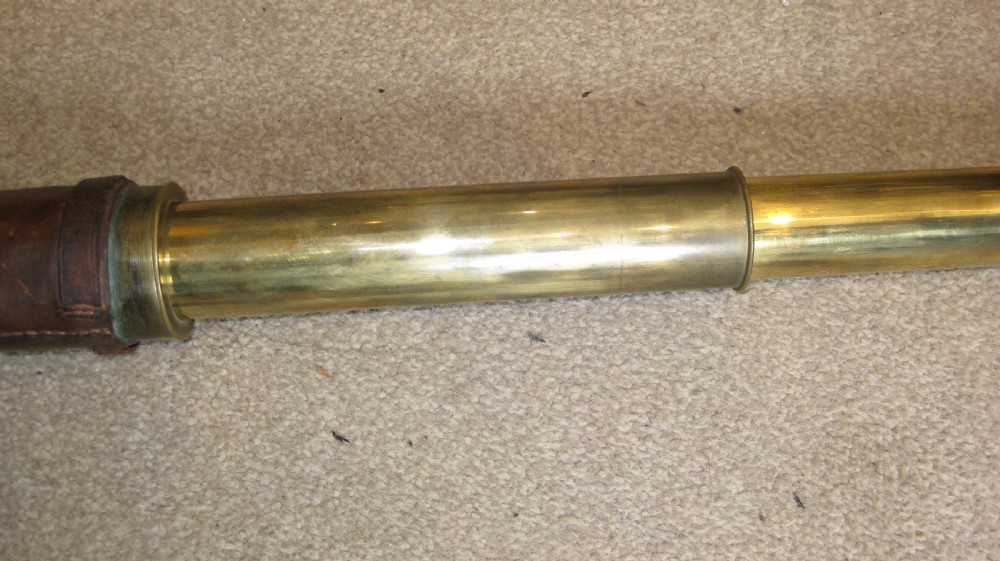 An extended four-draw antique brass telescope featuring a central stitched leather barrel sleeve. View III