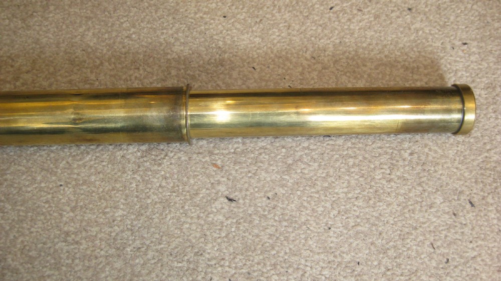 An extended four-draw antique brass telescope featuring a central stitched leather barrel sleeve. View IV