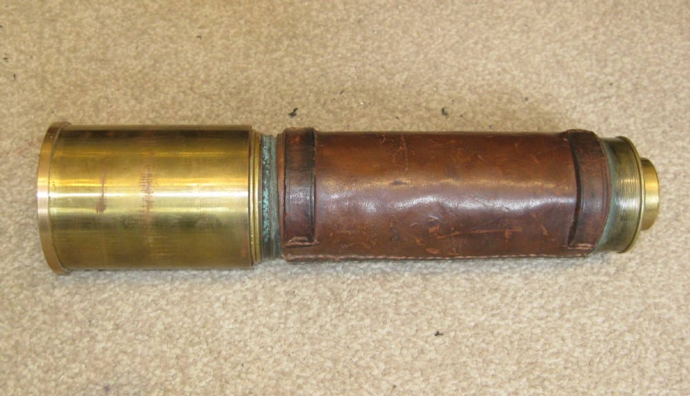 An extended four-draw antique brass telescope featuring a central stitched leather barrel sleeve. View VII