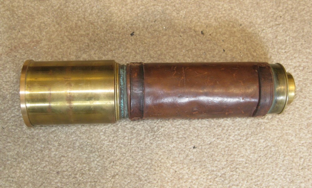 An extended four-draw antique brass telescope featuring a central stitched leather barrel sleeve. View VIII