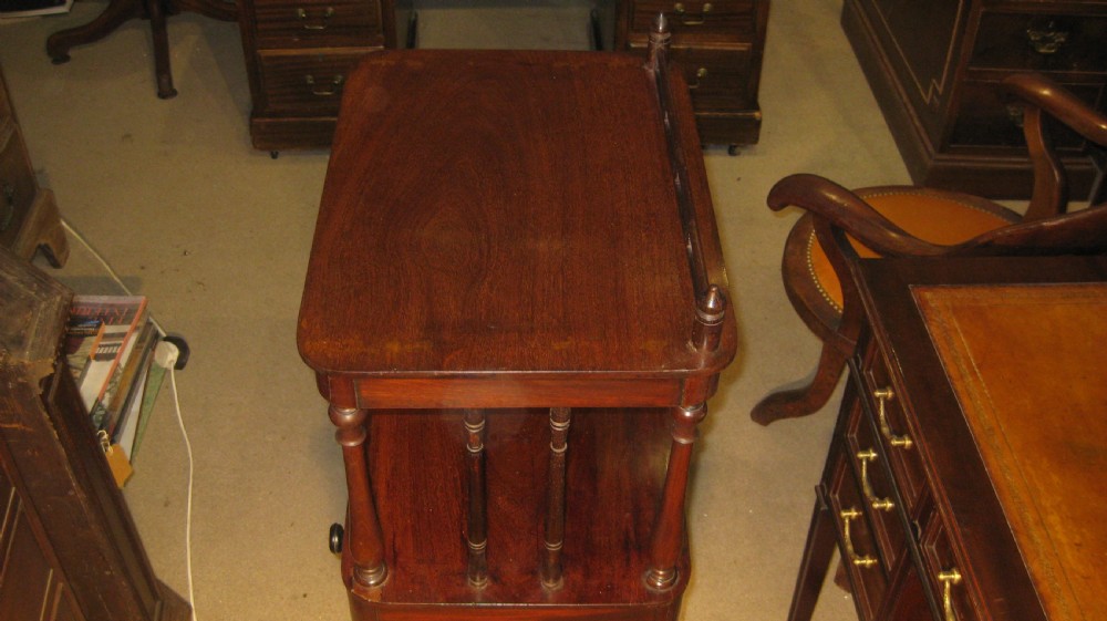 A Victorian mahogany three-tiered whatnot featuring turned support columns, a single drawer with turned wooden knobs, and a low top gallery with corner finials. View VII