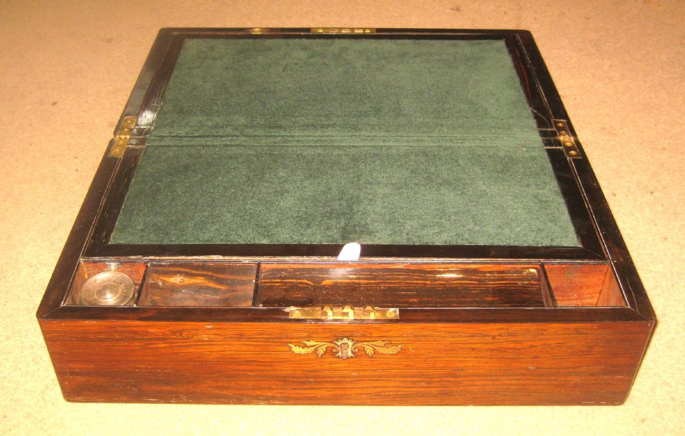 A rectangular Victorian rosewood writing slope featuring a figured grain finish with a central foliate inlay on the lid and an inlaid escutcheon on the front. View III