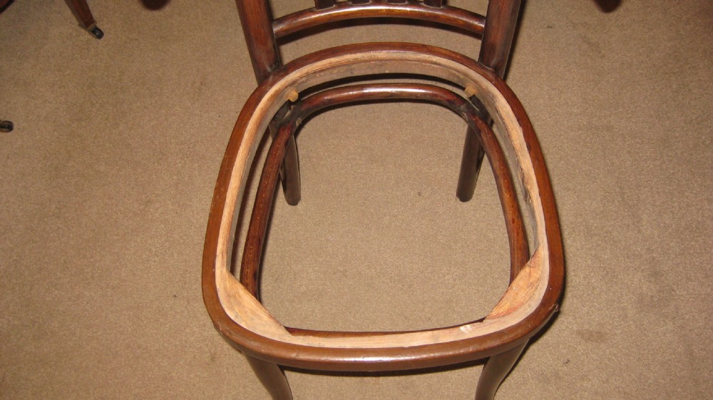 A dark brown steam-bent beechwood side chair featuring a curved backrest and a recessed frame for a drop-in seat pad. View V
