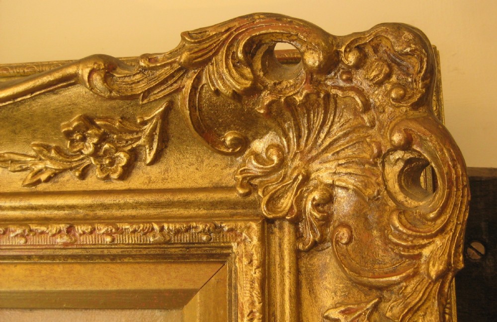 A 19th-century landscape oil painting depicting figures gathering wheat in an open field, set within a carved gilt wood frame. View IV