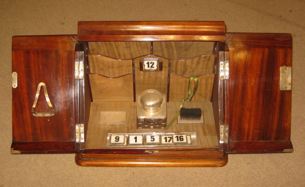 A late Victorian mahogany stationery cabinet featuring inlaid satinwood border detailing on double panelled doors and a central brass keyhole escutcheon. View II