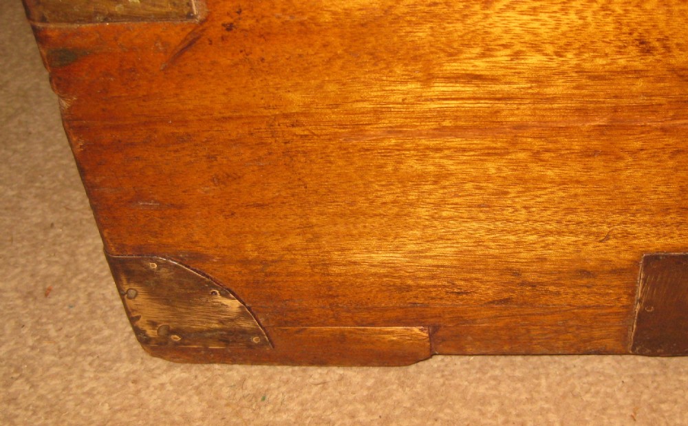 A rectangular solid camphorwood campaign trunk featuring visible wood grain, corner brass brackets, and a flush inset brass handle. View VI