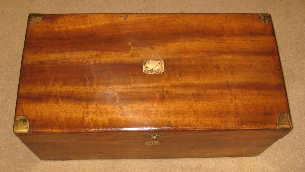 A rectangular Victorian solid camphorwood campaign trunk featuring polished brass corner mounts and central escutcheon. View II