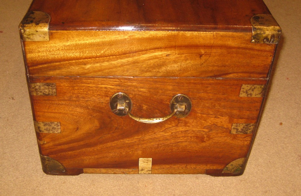 A rectangular Victorian solid camphorwood campaign trunk featuring polished brass corner mounts and central escutcheon. View V