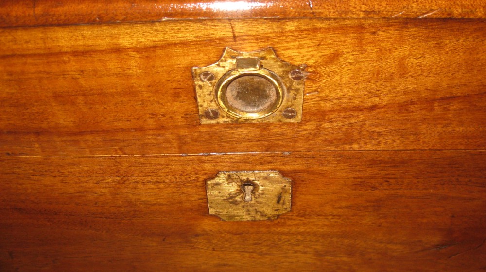 A rectangular Victorian solid camphorwood campaign trunk featuring polished brass corner mounts and central escutcheon. View VI