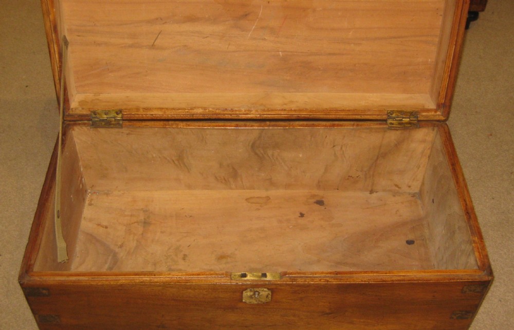 A rectangular Victorian solid camphorwood campaign trunk featuring polished brass corner mounts and central escutcheon. View VII