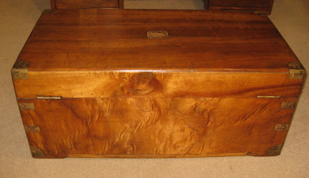 A rectangular Victorian solid camphorwood campaign trunk featuring polished brass corner mounts and central escutcheon. View IX