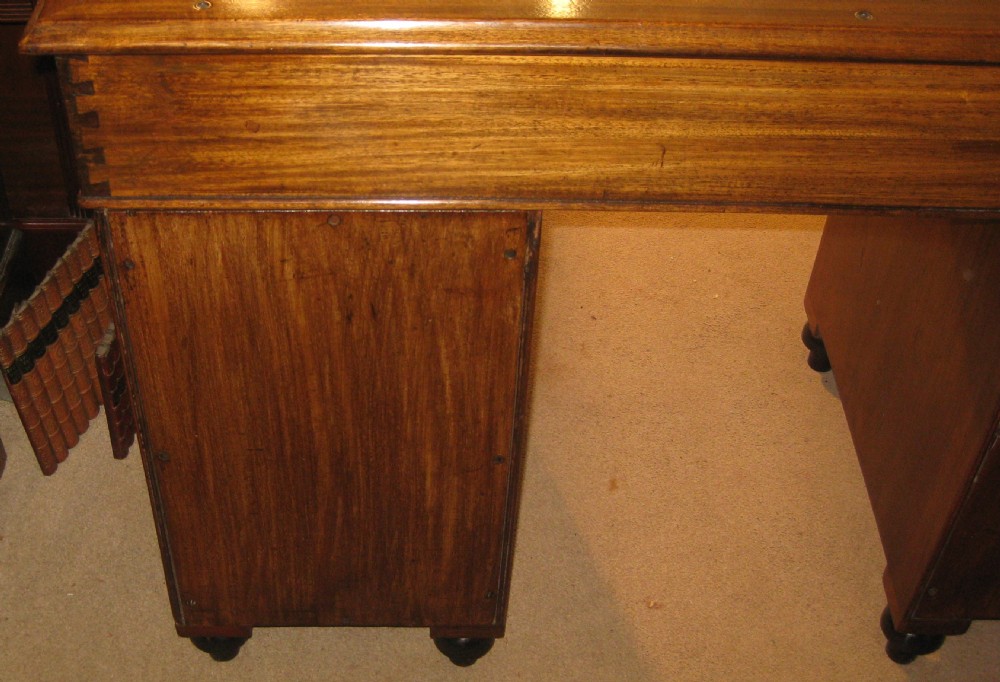 A Victorian mahogany campaign pedestal desk with a green leather top insert, recessed brass drawer pulls, and turned feet. View III