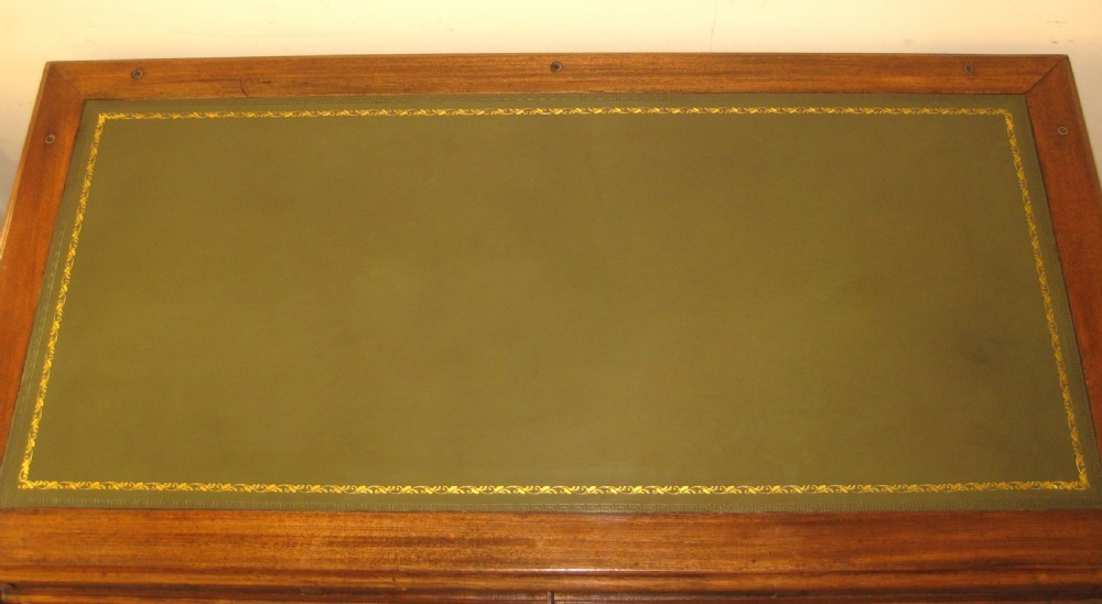 A Victorian mahogany campaign pedestal desk with a green leather top insert, recessed brass drawer pulls, and turned feet. View IX