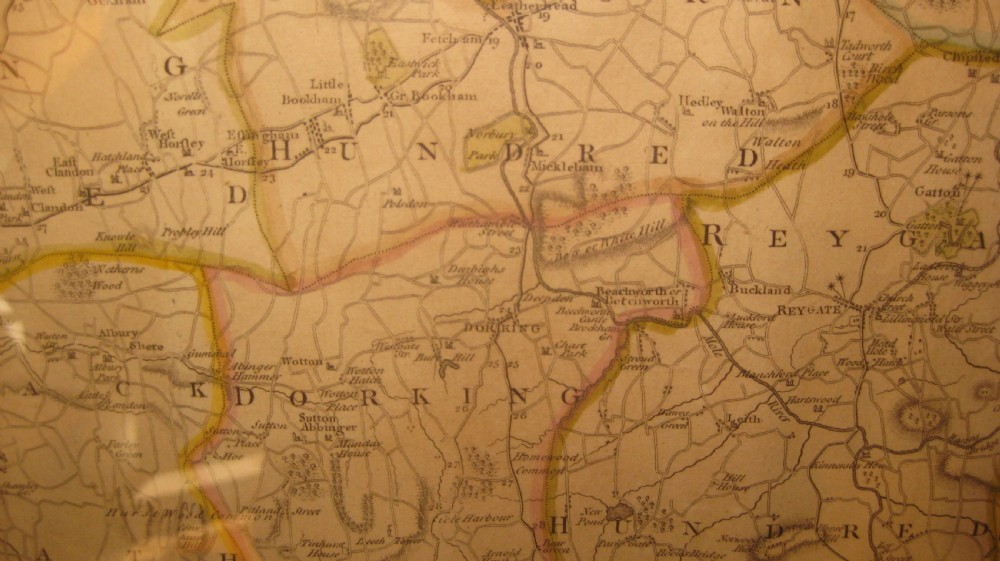 An antique hand-coloured engraved map of Surrey by John Cary set within a dark green mount and a thin gilt wooden frame. View VI