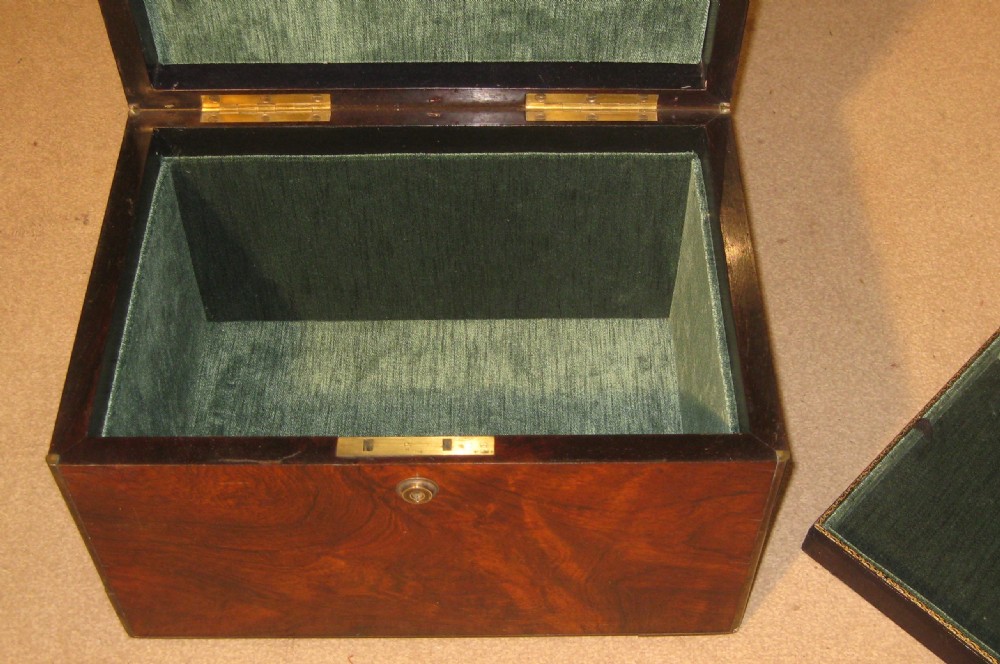 A rectangular Victorian rosewood jewellery box featuring brass edging, a central brass cartouche on the lid, and a brass keyhole escutcheon. View III