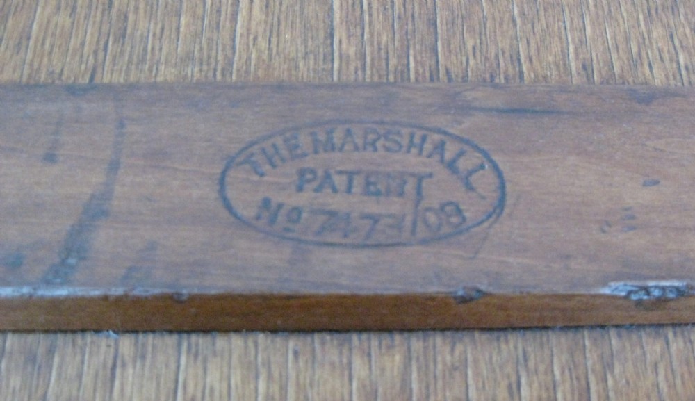 A rectangular wooden sea chest featuring black metal corner brackets, metal edge binding, and twin oval keyhole escutcheons. View II