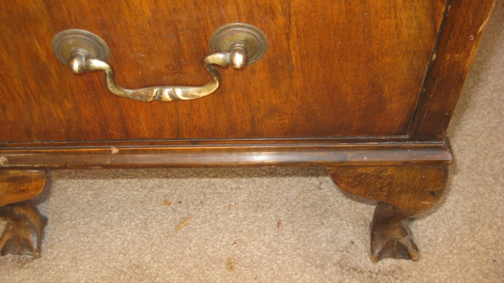 A late Victorian walnut pedestal desk featuring a leather-lined writing surface, multiple drawers with brass swan-neck handles, and carved cabriole feet. View V