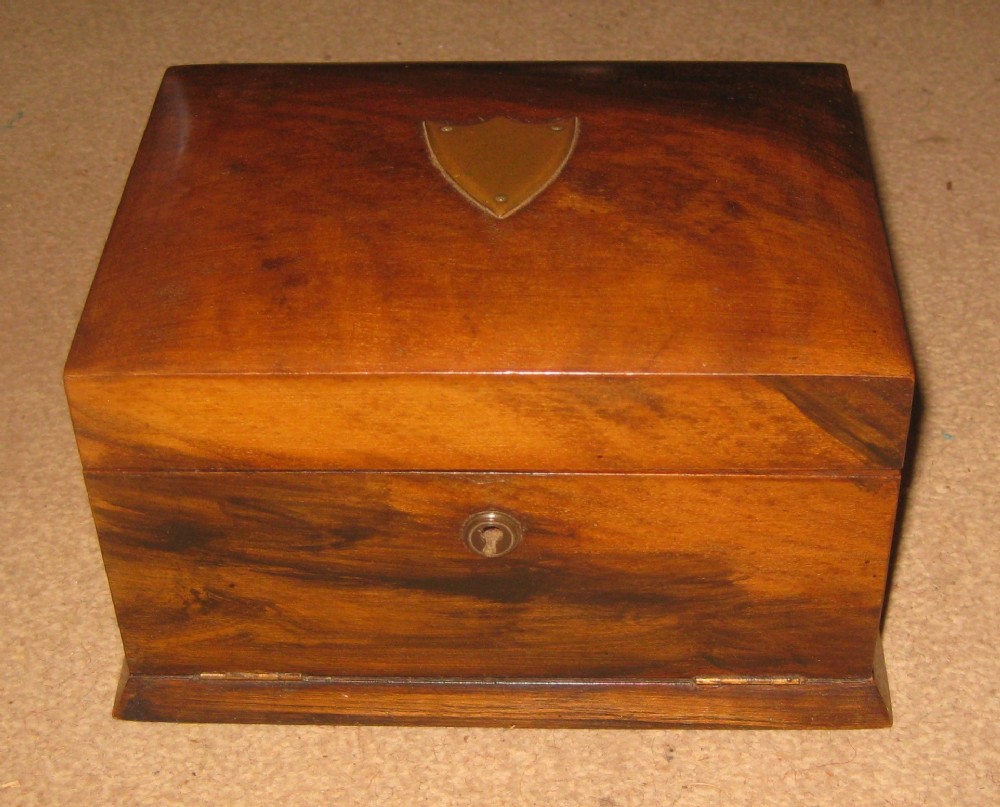 A rectangular Victorian walnut jewellery box featuring a brass shield escutcheon on the hinged lid and a central brass keyhole on the front face.