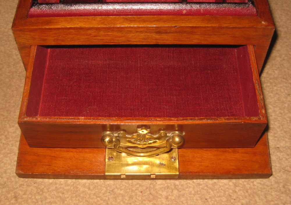 A rectangular Victorian walnut jewellery box featuring a brass shield escutcheon on the hinged lid and a central brass keyhole on the front face. View III