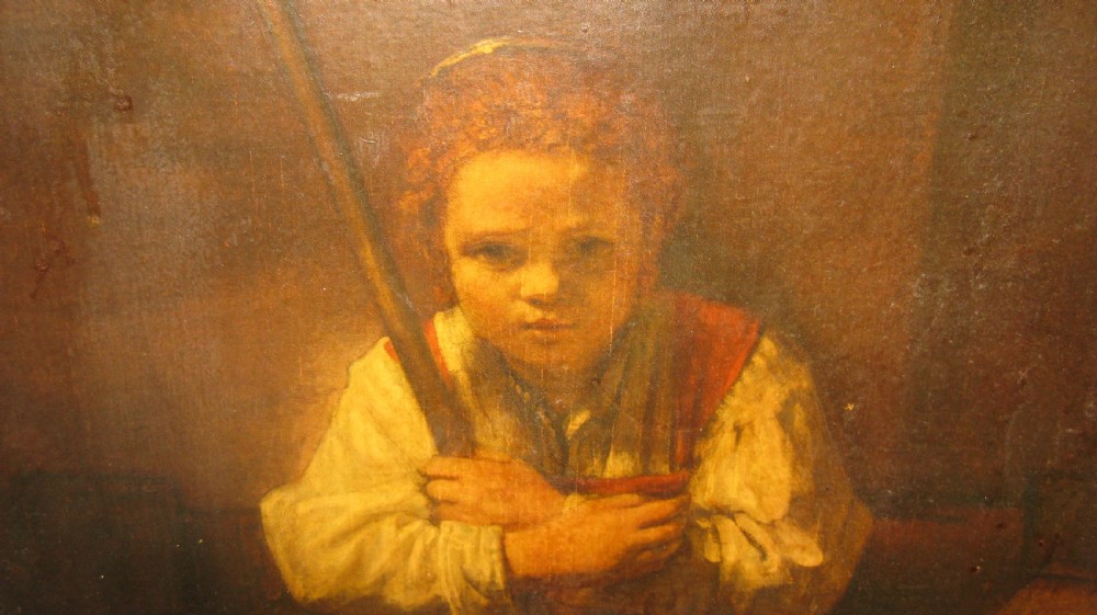 An oil painting depicting a young girl holding a broom set within an ornate gilded frame. View II