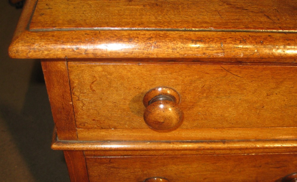 A Victorian mahogany pedestal desk featuring nine drawers with turned wooden handles and a central kneehole. View VI