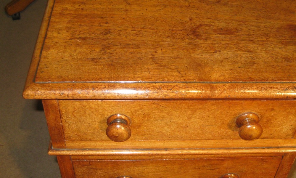 A Victorian mahogany pedestal desk featuring nine drawers with turned wooden handles and a central kneehole. View VII