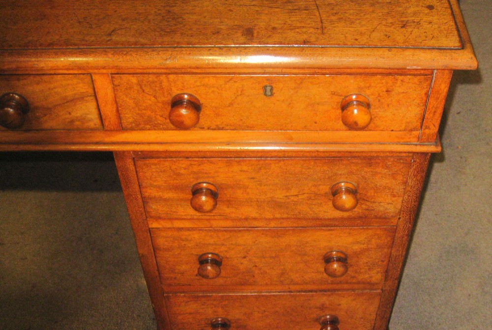 A Victorian mahogany pedestal desk featuring nine drawers with turned wooden handles and a central kneehole. View VIII