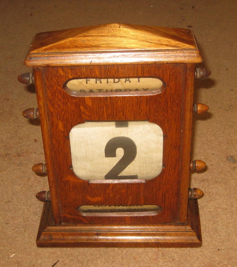 Edwardian oak desk top perpetual calendar. 