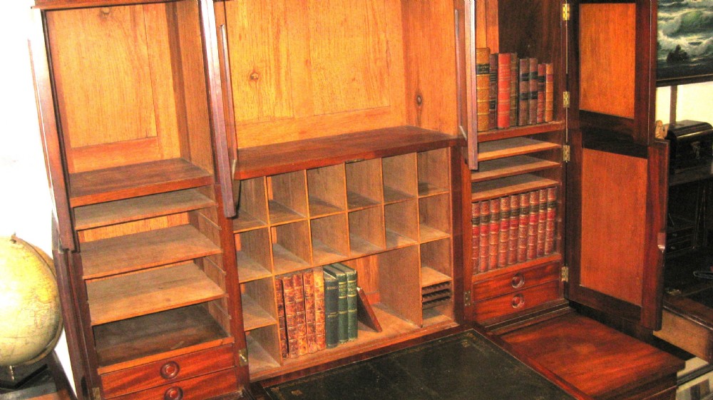 A Victorian mahogany estate managers desk featuring twin pedestal drawers and a fitted upper cabinet with panelled cupboard doors. View V