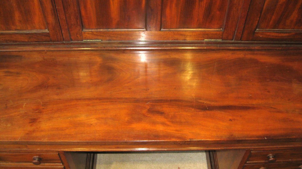 A Victorian mahogany estate managers desk featuring twin pedestal drawers and a fitted upper cabinet with panelled cupboard doors. View X