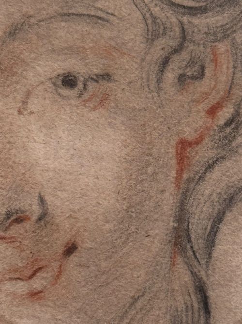fig 1. An eighteenth-century oval portrait drawing on beige paper depicting a young womans head in red and black chalk.