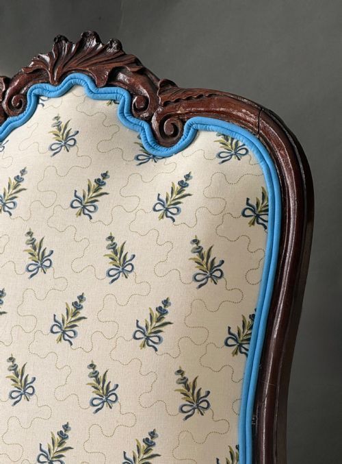 fig 1. A pair of Dutch Baroque mahogany side chairs featuring carved cabriole legs and floral upholstered backs and seats with blue trim.