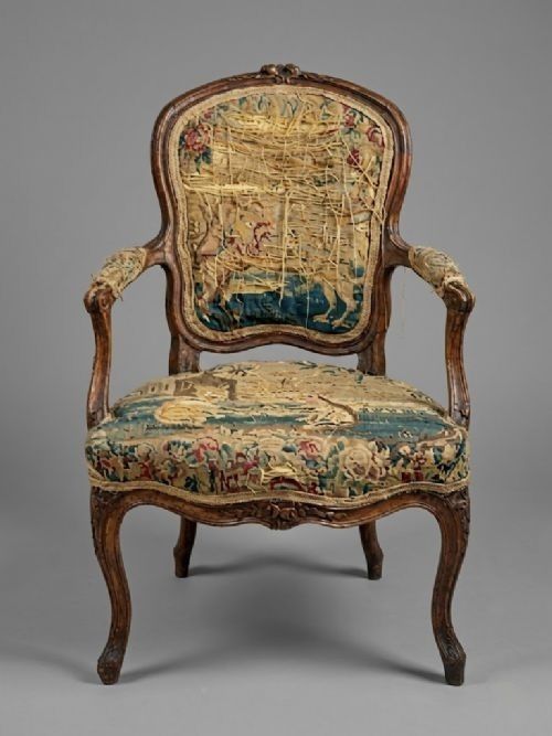 fig 2. A pair of late eighteenth-century Louis XV style carved wooden fauteuil armchairs upholstered in floral Aubusson tapestry featuring cabriole legs and curved armrests.