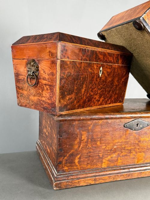 fig 1. A collection of three antique 18th-century wooden boxes stacked together, featuring a sarcophagus lid, fitted glass bottles, and detailed metal escutcheons.
