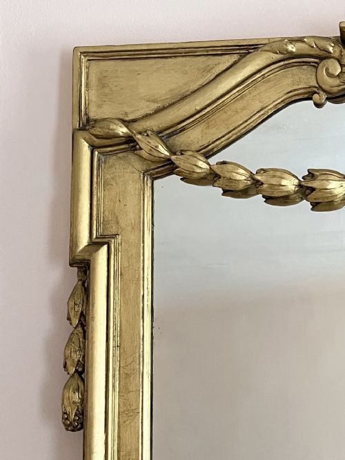 fig 2. A large 19th-century rectangular giltwood overmantel mirror featuring an inner arched frame adorned with hanging laurel leaf festoons and classical fluted mouldings.